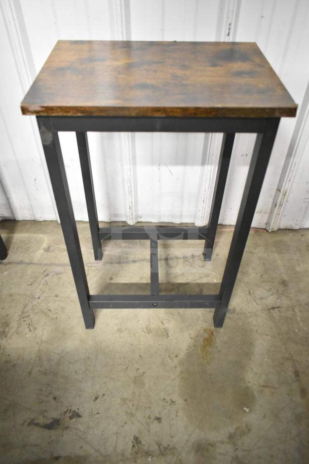 24 wood-patterned tables with black metal frames, bar-height. Durable design, ideal for modern settings. Auction lot includes 24 units.