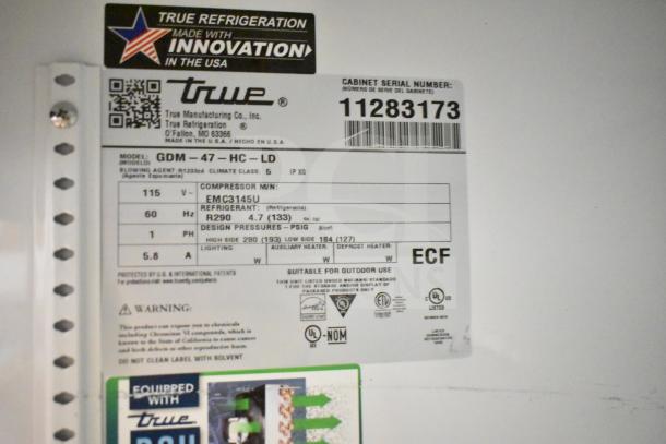 True GDM-47-HC-LD Cooler Merchandiser label showing model details, 115V, refrigerant type, and serial number 11283173.