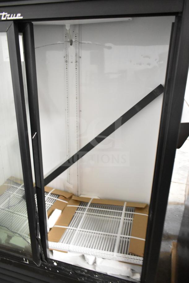 "2025 True GDM-47-HC-LD commercial 2-door reach-in cooler, showing interior shelving. Brand new with scratch and dent. 115V, 1 phase."