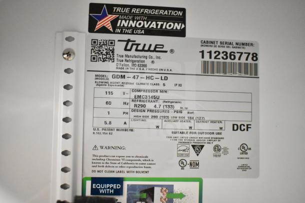 True GDM-47-HC-LD cooler label indicating model, 115V, 1 phase. Missing doors, brand new, scratch and dent condition.