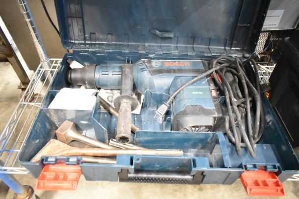 Bosch RH745 Rotary Hammer in hard case. Features 120 volts, 1 phase, with power cord and attachments. Appears in good condition.
