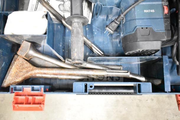 Bosch RH745 Rotary Hammer in blue hard case, labeled (RH745). Includes power cord and accessories. Some rust on tools. 120 Volts, 1 Phase.
