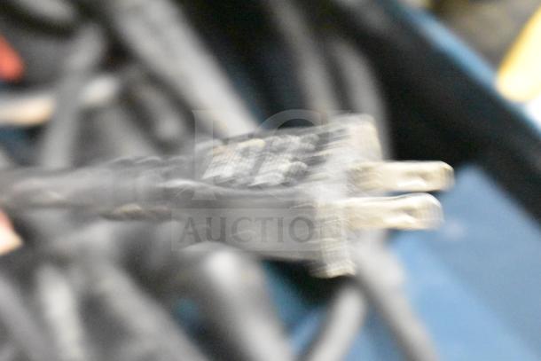 Blurred close-up of Bosch RH745 Rotary Hammer power plug, 120V, 1-phase, in its hard case.