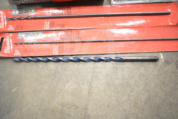 DeWalt hard tool box with Hilti tool, assorted drill bits, and Milwaukee drill bits in packaging, showing minor wear.