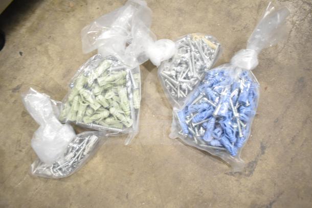 DeWalt hard tool box containing a Hilti tool and various drill bits, showing bags of screws and wall plugs.