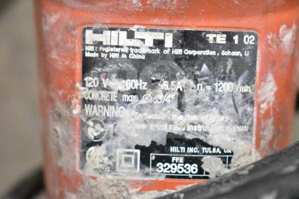 DeWalt tool box with Hilti TE 1 tool, visible wear. Label shows model info: 120V, 60Hz, 5.5A. Includes various drill bits.