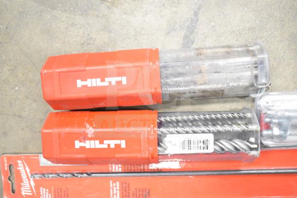 DeWalt hard tool box with contents including Hilti drill bits in red cases and a Milwaukee bit set.