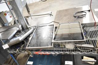 Three electronic items including Kitchen Armor monitor, Thin Client Mini PC, and a third unidentified device on a wire shelf.