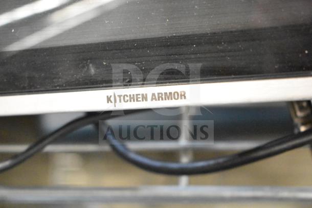 Kitchen Armor monitor detail with visible brand label, showing sleek design. Part of auction lot including a Thin Client Mini PC.