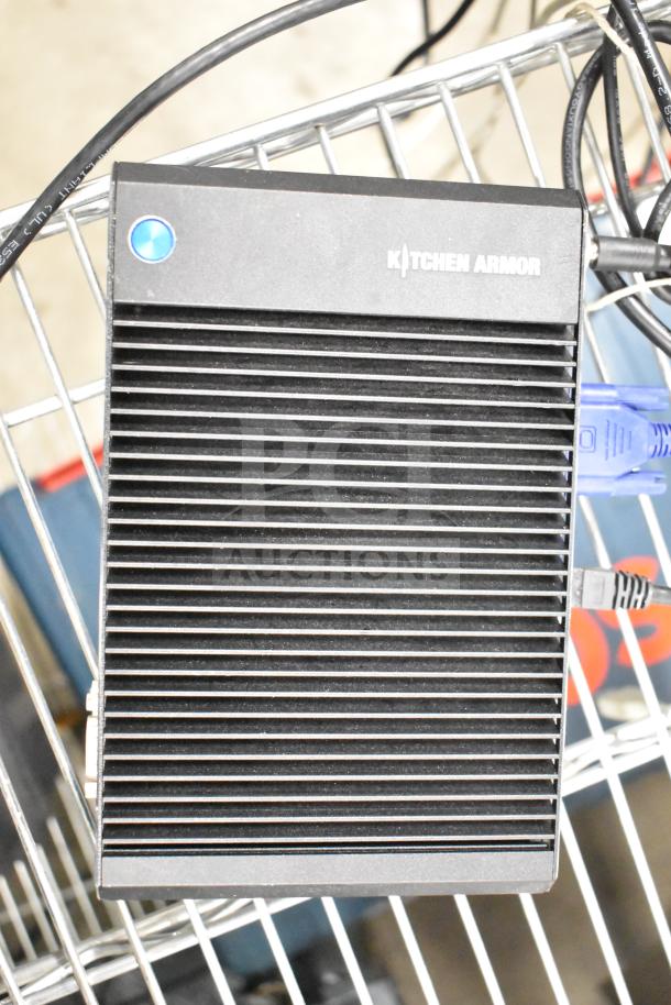 Kitchen Armor monitor with ribbed design, black casing. Includes visible cables. In good condition.