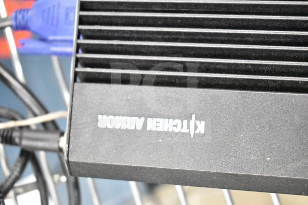 Kitchen Armor Monitor in good condition, black finish, features visible brand label. Part of a three-item auction lot.