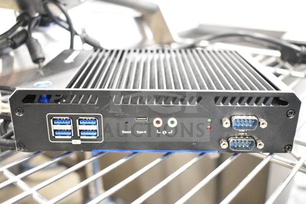 Thin Client Mini PC with multiple USB ports, audio jacks, and serial connections. Good condition, ideal for compact computing.