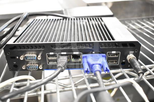 Thin Client Mini PC with multiple ports including USB, VGA, and LAN. Black metal casing, good condition.