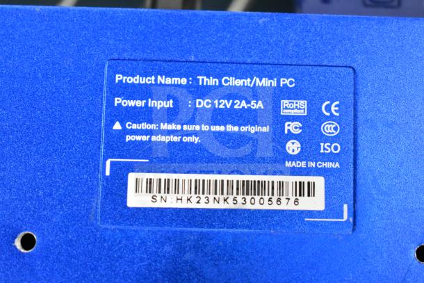 Blue label of Thin Client Mini PC showing power input DC 12V 2A-5A, certifications, and serial number SN: HK23NK53005676.