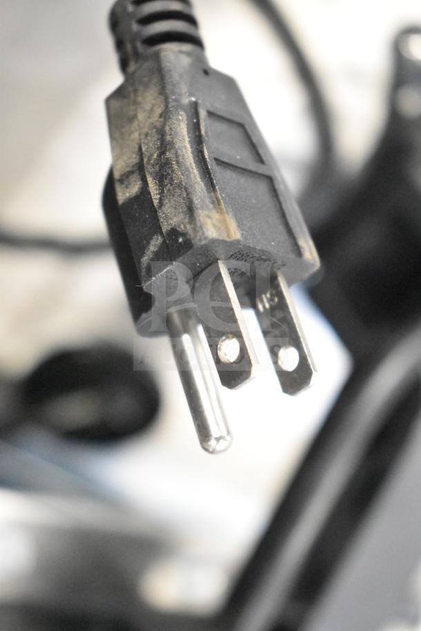 Close-up of a black electrical plug for a Kitchen Armor Monitor or Thin Client Mini PC auction item bundle.