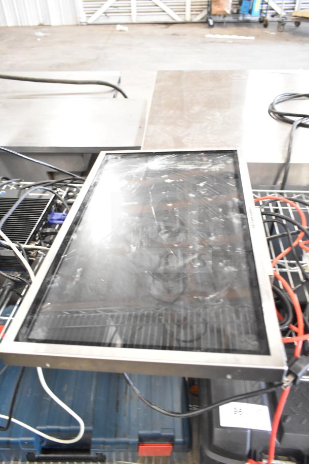 Three electronic items including a Kitchen Armor monitor, a thin client mini PC, and cables. Monitor shows scratches.