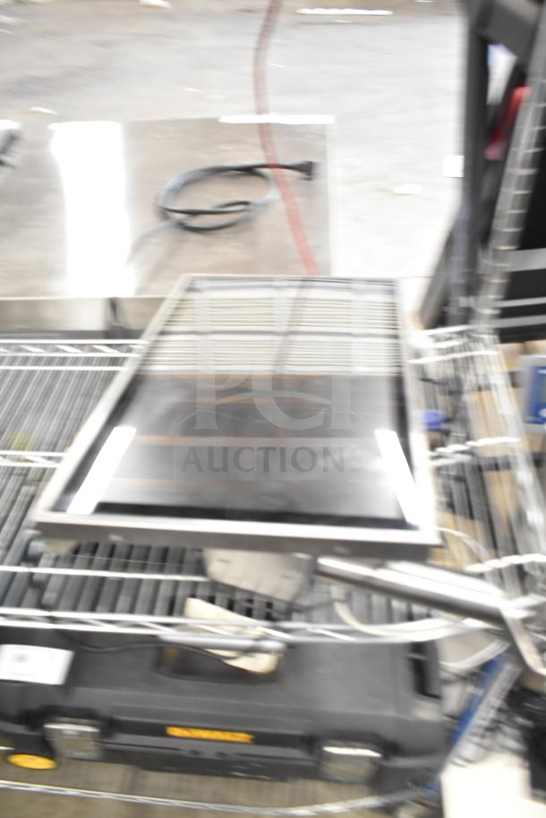 Blurred image of a Kitchen Armor Monitor, part of a lot with a Thin Client Mini PC. Items on a storage cart.