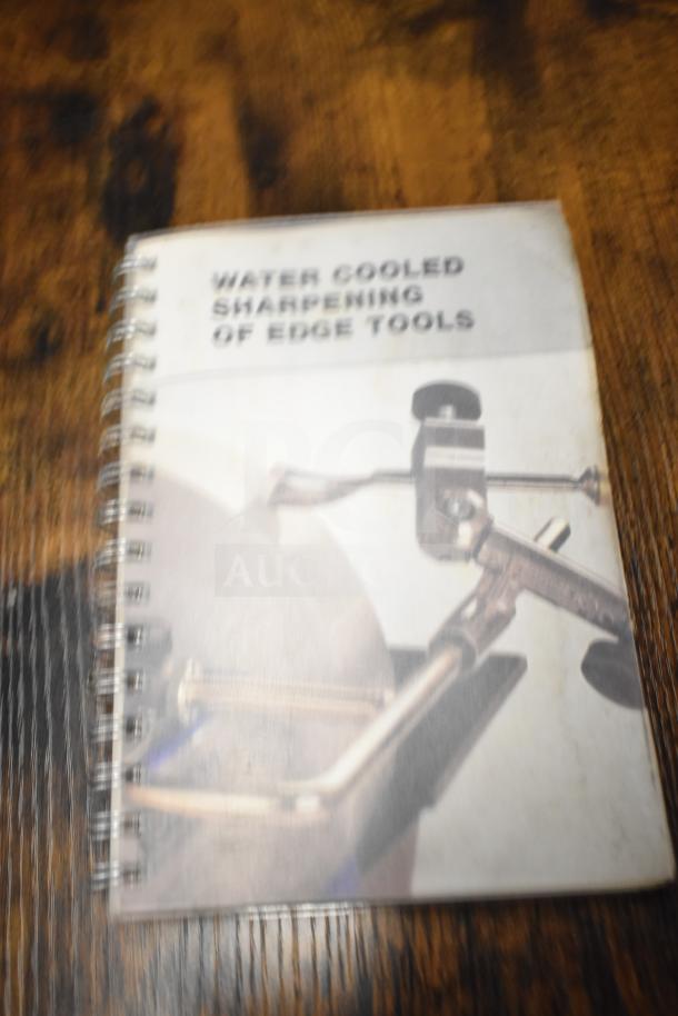 Lot includes a spiral-bound book titled "Water Cooled Sharpening of Edge Tools," showing slight wear on the cover.