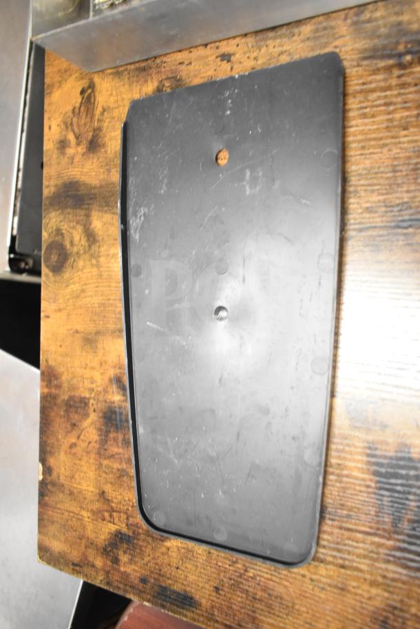 Gray poly bus bin on a wooden surface, part of a mixed auction lot. Moderate wear visible, no labels or markings.