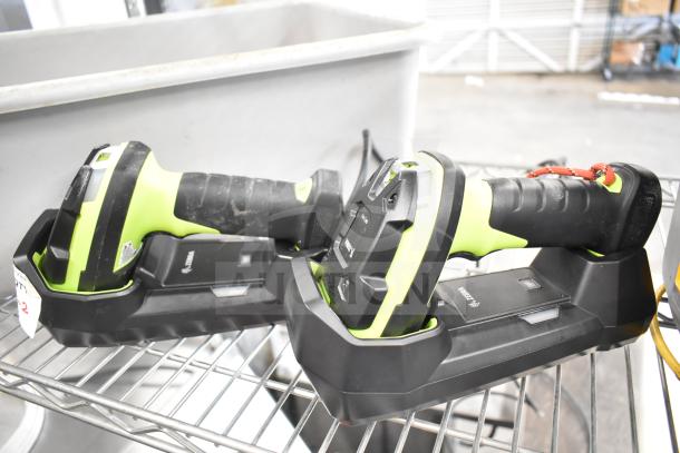 Two Zebra DS3578 barcode scanners with charging bases, black and green, used condition, visible brand logo.