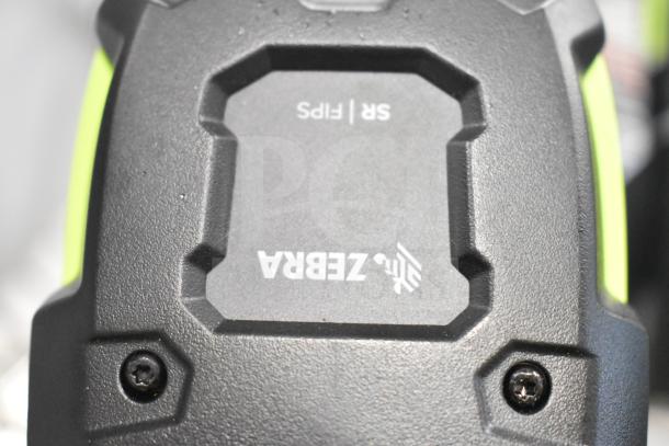 Zebra DS3578 barcode scanner, black and green, rugged design. Marking shows "Zebra SR Flips." Good condition.