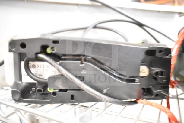 2 Zebra DS3578 barcode scanners, black, shown on a metal shelf. Some cables are visible. Condition appears used.