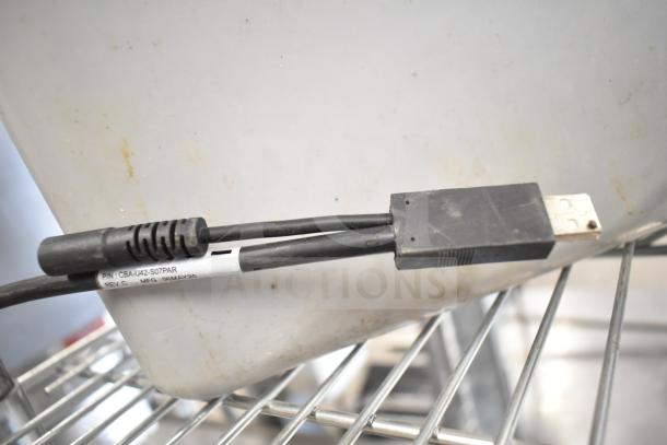 Zebra DS3578 Barcode Scanner cable, P/N CBA-U42-S07PAR, shown with USB connector, metal shelving in background.