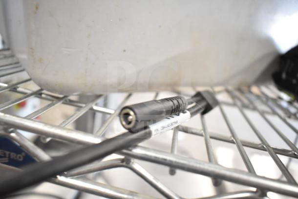 Two Zebra DS3578 barcode scanners on a metal shelf, showing a connected cable with label, indicating connectivity features.