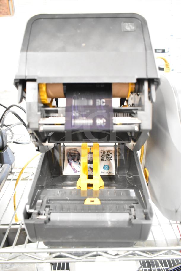 Zebra ZD621 desktop direct thermal barcode printer in open position, showing internal components. Clean and well-maintained.