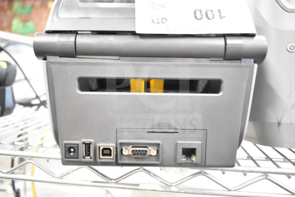 Zebra ZD621 desktop direct thermal barcode printer with various connectivity ports. Auction includes two units.