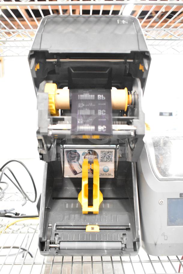 Zebra ZD621 desktop direct thermal barcode printer, open view, showing internal components and label roll.