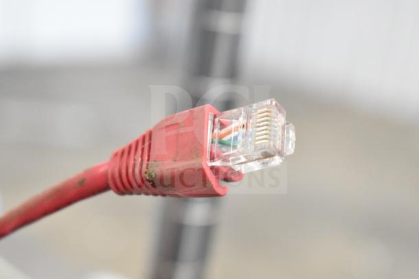 A red Ethernet cable with visible wear and exposed wires at the connector.