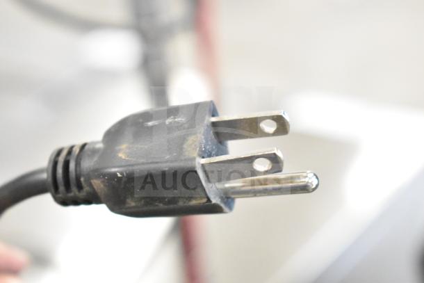 Close-up image of a power plug, possibly associated with the Zebra ZT411 industrial barcode printer.