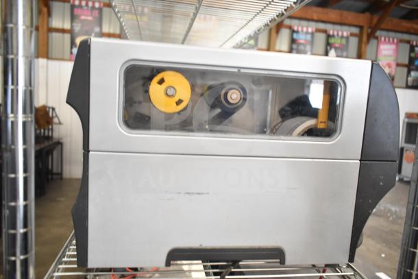 Zebra ZT411 Industrial Barcode Printer, used condition, visible inner components, grey and black casing, transparent side panel.