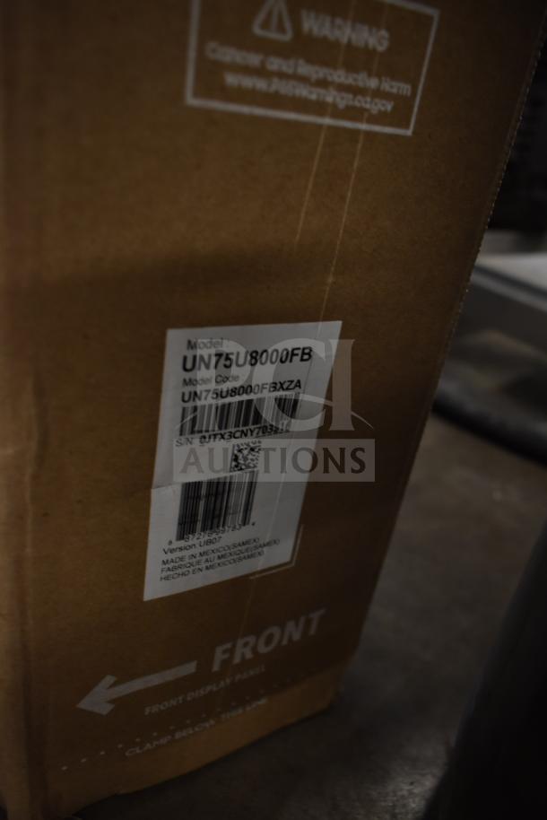Box with model label "UN75U8000FB," indicating a 75" television. Item condition not verified. Pickup required.