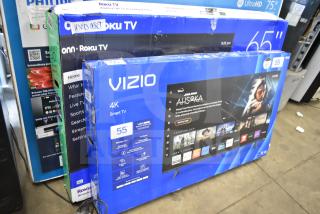 Vizio 55" 4K Smart TV and Roku 65" TV in original boxes, condition unverified. Labels indicate "used asset." Pickup only.