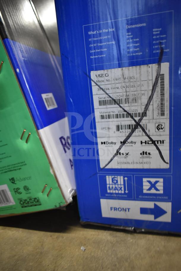 Boxes containing a Vizio 55" LED UHD TV and Roku 65" TV. Labels show dimensions and shipping instructions. Condition unverified.