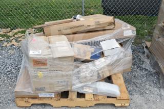 Palette with 13 new scratch-and-dent items wrapped in plastic, including mobile desk and shelving unit. Boxes show product details.