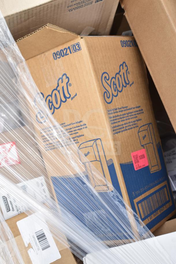 Boxes labeled "Scott" in protective wrapping, indicating 13 brand new scratch and dent items, possibly including a mobile desk and shelving unit.