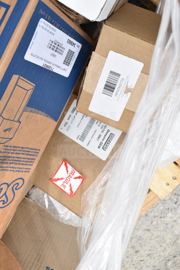 A collection of 13 new scratch and dent items including a mobile desk, shelving unit, and light. Boxes show fragile and shipping labels.