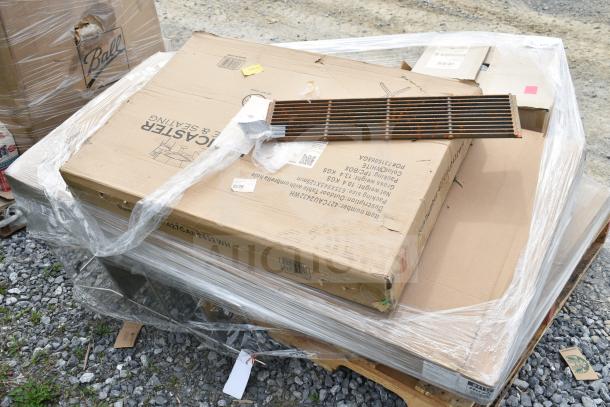 Pallet of 13 new scratch and dent items, including mobile desk and shelving unit, wrapped in plastic on gravel.