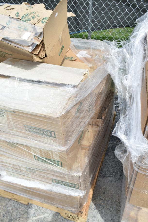 Stack of cardboard boxes labeled "USA," wrapped in plastic, containing hot cup sleeves and miscellaneous new items.