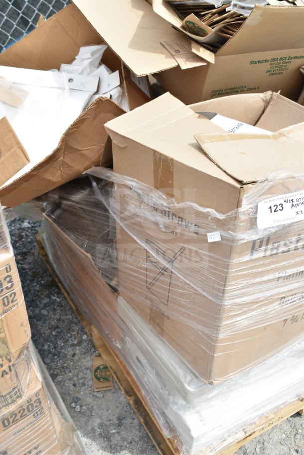 Cardboard boxes of scratch and dent hot cup sleeves, labeled "Starbucks USA." Items are palletized and shrink-wrapped.