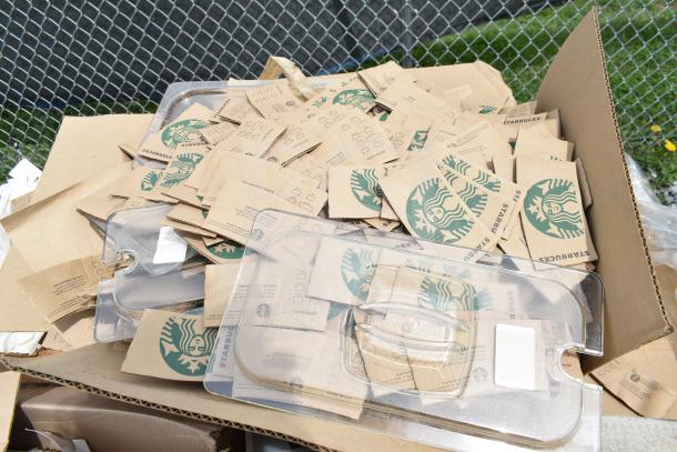 Cardboard box with Starbucks hot cup sleeves, new condition, some with scratch and dent, featuring logo and drink checkboxes.