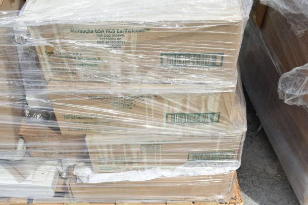 Stack of boxed Starbucks USA HCS Earthsleeve hot cup sleeves, wrapped in plastic, brand new condition.