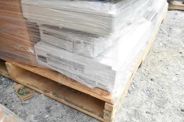 20 scratch and dent items on wood pallet, wrapped in plastic. Includes hot cup sleeves marked with Starbucks logo.