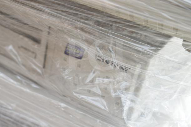 Wrapped pallet of assorted Sony branded items. Marking visible through plastic: "2.3/2.5" and another "Sony" label. Items are scratch and dent condition.