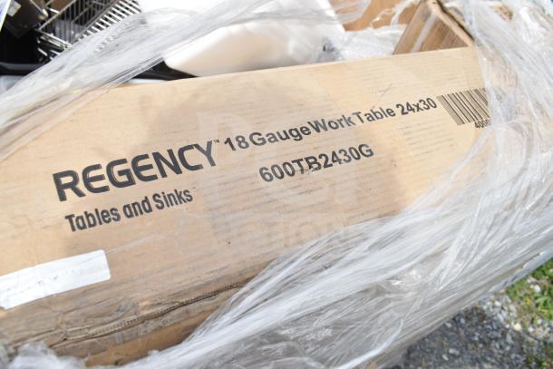 Regency 18 gauge work table 24x30 in box, model 600TB2430G, new scratch and dent condition, visible packaging.
