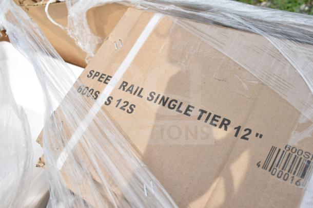 Cardboard box labeled "Speed Rail Single Tier 12" 600SS 12S," wrapped in plastic, part of auction lot.