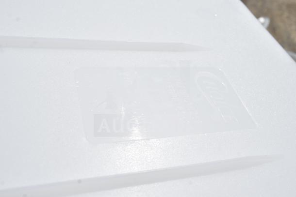 Label on white surface showing unidentified embossed markings.